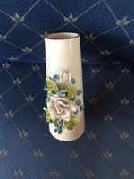 Porcelain vase with plastic flower decoration, without marking.11 Cm high
