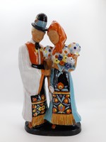A large pair of sculptures in a folk costume by Jolán Szécsi