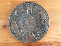 Scene-shaped wall plate with bronze hunter with gallery label