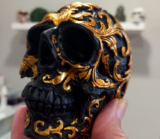 Richly decorated black realistic skull with a special ornamental motif