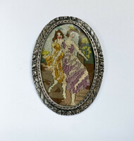 Old ornate silver brooch with tapestry image