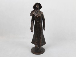 Statue of a woman in a hat with a bronze rose