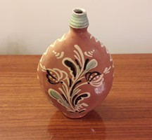 Old ceramic water bottle with folk motif cognac boutique bottle