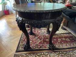 Old, beautifully shaped table with a devil's head