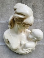 Earthenware wall decoration. Mary with her child.