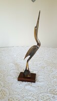Retro old heron sculpture from horn on wooden pedestal