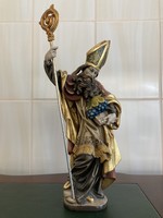 Statue of a wooden carved figure depicting a religious person