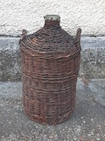 Glass bottle blown into an old shape, in cane braid