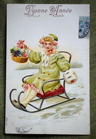 Antik dombornyomott Újévi üdvözlő litho képeslap kisleány szánon kosárral szerencsepatkó