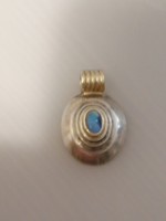Silver-plated pendant decorated with an opal stone. Partially gilded.
