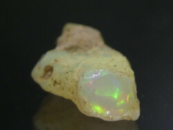 Natural Ethiopian opal specimen. 0.75 grams of jewelry base material, with glitters in a rich variety of colors.