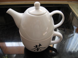 White porcelain teapot with mug