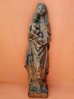 Virgin Mary with baby Jesus in her arms. Wood carving. Wooden statue.