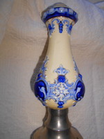 An antique majolica vase with a metal base