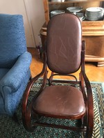 Rocking chair with leather upholstery. In new condition. 90 cm high.