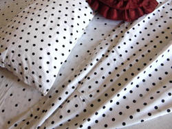Black polka dot bedding set on a white background
