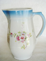 Old floral folk porcelain jug pouring
