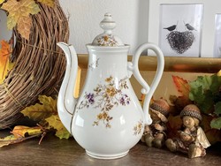 Antique porcelain teapot with small flowers