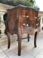A small dresser with a marble top in a nice shape