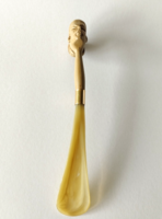 Old shoe spoon with woman's head