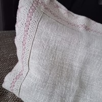 Old woven decorative cushion with lace edge