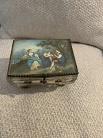 Old glass jewelry box with a romantic scene