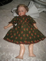 Porcelain doll, marked, nicely dressed, skirt, underwear, etc...