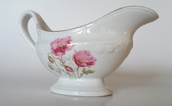 Old flower patterned porcelain sauce bowl with poppy sole pouring