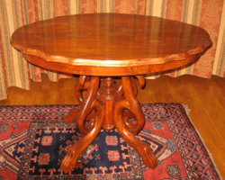 Turn of the century antique table with spider legs in room condition