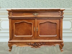 An antique chest of drawers with a marble top