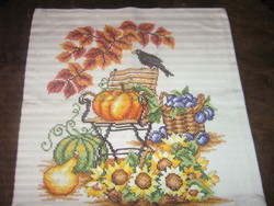 Decorative pillow with autumn pattern made with beautiful cross-stitch embroidery