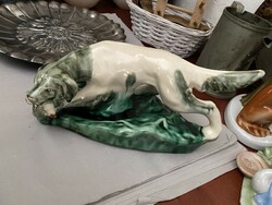 Porcelain hunting dog with a pheasant in its mouth