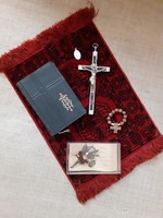 Old German Christian heirloom prayer book in a box with mother-of-pearl rosary with relics on a small tablecloth