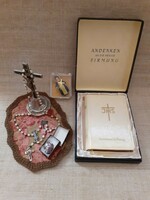 Old German Christian heirloom prayer book in a box with mother-of-pearl rosary with relics on a small tablecloth