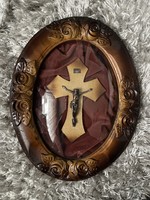 Beautiful carved rosy wooden frame with cross on burgundy velvet.