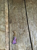 Aura quartz mineral with gold colored necklace