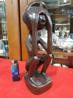 Hand-carved solid wood figural sculpture.