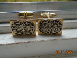 Gold-plated cufflinks with niello star marks.