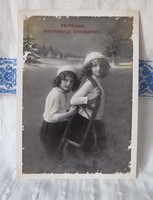 Reprint postcard based on an antique Christmas postcard, little girls, sled, snowy landscape