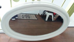 Old mirror with white oval wooden frame