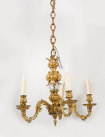 Gilded bronze chandelier with a glass globe in the middle