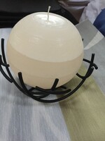 Decorative, metal candle holder with a huge spherical candle