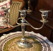 Silver-plated three-pronged, elegant candle holder for festive occasions to enhance the festive atmosphere.