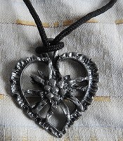Snowflake pattern heart pendant on a string