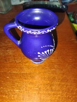 Blue ceramic jug with white hand painting