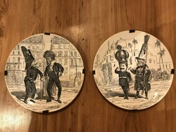 A pair of decorative plates depicting an antique political caricature, signed