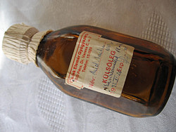 Unopened 1992 pharmacy lactic acid in a brown screw bottle