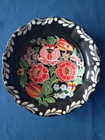 Decorative plate painted on a black background