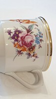 Huge, thick porcelain mug. With floral decor and gilding.