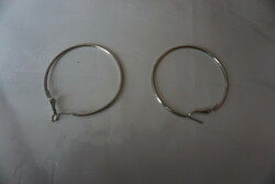 Stainless, smooth, polished metal alloy plug-in hoop earrings for sale.